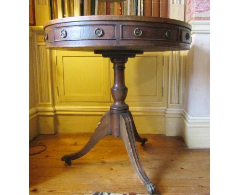 An early 20th century drum table of small dimensions with four alternating real and dummy drawers on turned pillar and tripod