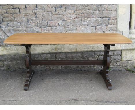 An Ercol refectory dining table with light elm top on a dark refectory base, 180cm long