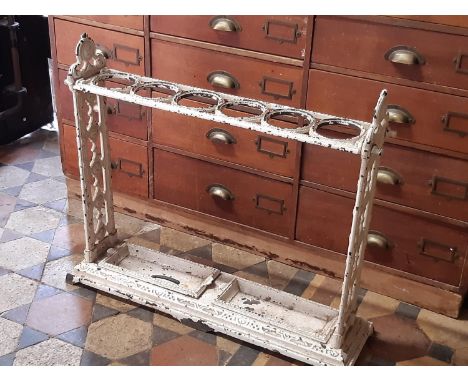 A 19th century cast iron stick or umbrella stand with six circular divisions and with original iron drip tray, 75cm long 