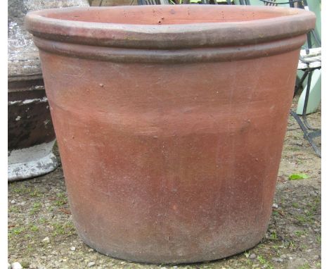 A substantial matt glazed terracotta garden planter of circular tapered form, 80 cm diameter x 64 cm high 