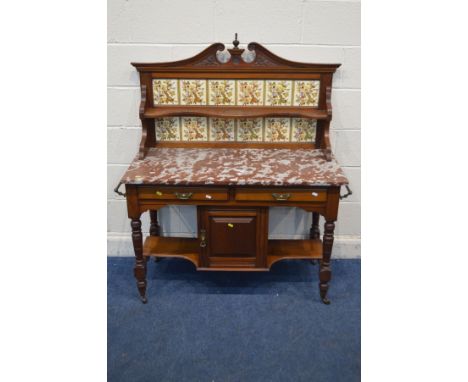 AN EDWARDIAN WALNUT MARBLE TOPPED WASHSTAND, with a floral tile back, two drawers, single cupboard door, and two brass handle