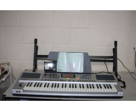 A ROLAND E-200 INTELLIGENT KEYBOARD with manual, dp-2 footswitch, box and stand (PAT pass and all keys and sounds working)