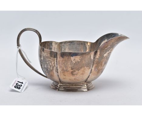 A GEORGE V SILVER GRAVY BOAT, of a plain polished wavy edge design, tapered handle, on a raised hexagonal base, base stamped 