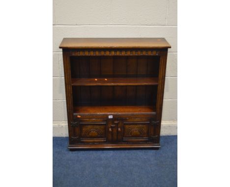 A TITCHMARSH AND GOODWIN OAK OPEN BOOKCASE, with a single shelf, above double cupboard doors, width 84cm x depth 27cm x heigh