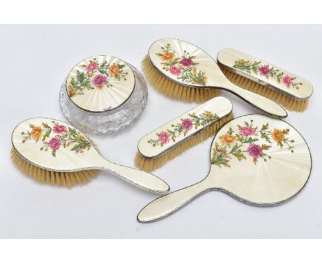 A SILVER AND GUILLOCHE ENAMEL VANITY SET, to include two hairbrushes, a handheld mirror, two clothes brushes and a cut glass 