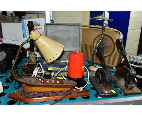 A GROUP OF LAMPS, RADIOS, PAPER EMBOSSERS, etc, including a wooden boat shaped lamp, a Bush radio, a brown bakelite lamp base