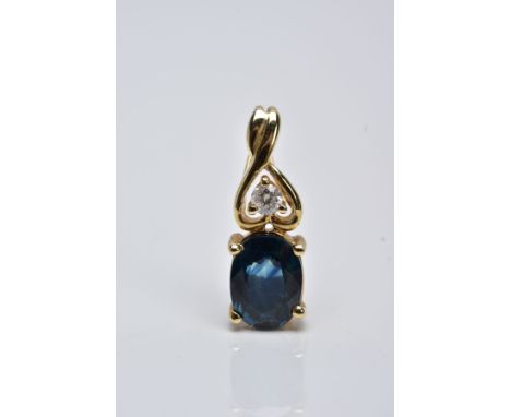 A YELLOW METAL SAPPHIRE AND DIAMOND DROP PENDANT, designed with an oval cut claw set blue sapphire, fitted with an openwork c