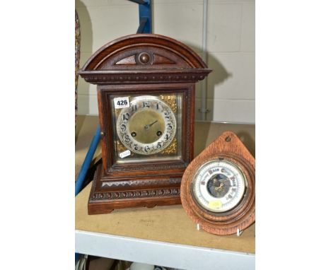 A LATE 19TH CENTURY OAK CASED MANTEL CLOCK, the silvered dial with Arabic numerals, 8 day movement, gong strike, with pendulu