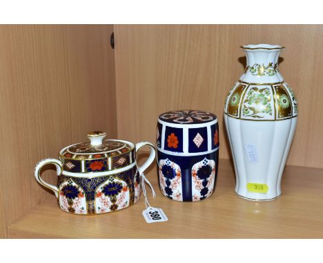 THREE PIECES OF ROYAL CROWN DERBY, comprising an 1128 Imari twin handled oval sucrier and cover, seconds, gilding fault to fi