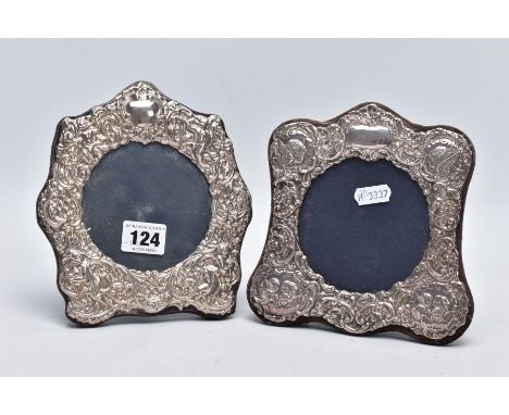 TWO ORNATE SILVER FRAMES, each with a decorative cherub and foliate embossed design, vacant cartouche, each hallmarked London