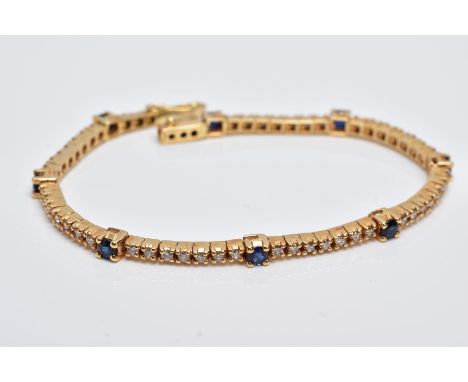 A YELLOW METAL DIAMOND AND SAPPHIRE LINE BRACELET, set with round brilliant cut diamonds, total estimated diamond weight 1.68