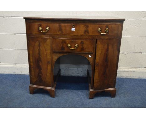 A GEORGIAN MAHOGANY, CROSSBANDED AND STRUNG BOWFRONT SIDEBOARD, with a single long oak lined drawer above cupboard doors encl