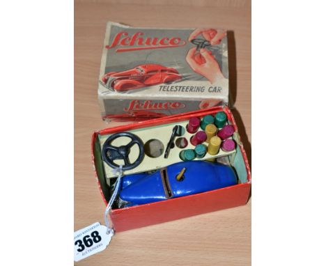 A BOXED SCHUCO TELESTEERING 3000 CAR, playworn condition, missing ball and some of the wooden skittles but complete with stee