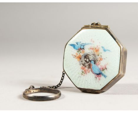 A SMALL SILVER AND ENAMEL COMPACT on a chain.