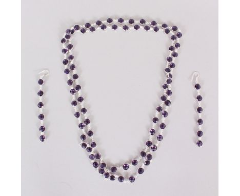 A SILVER AND AMETHYST NECKLACE AND LONG EARRINGS in a box.