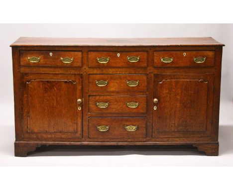A GOOD 18TH CENTURY OAK DRESSER BASE, with plain top, the front with three frieze drawers over three central drawers, flanked