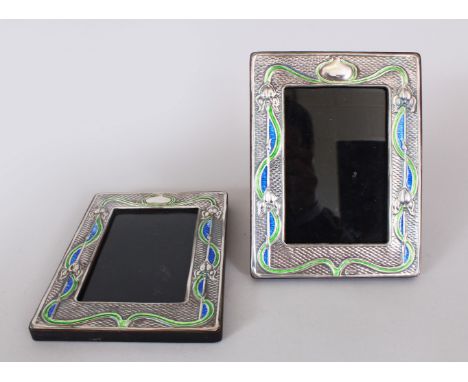 A PAIR OF ART NOUVEAU DESIGN SILVER ENAMEL PHOTOGRAPH FRAME. 18cms x 14cms.