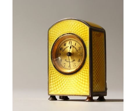 A TINY SILVER AND YELLOW ENAMEL CLOCK by MORASCA &amp; ROSSELLO, MONTEVIDEO. 4.5cms high.