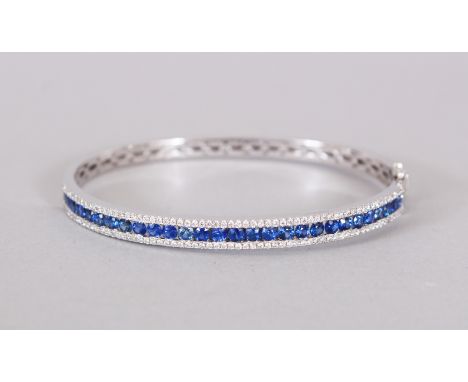 AN 18CT WHITE GOLD SAPPHIRE AND DIAMOND BANGLE of 2.5cts approx.