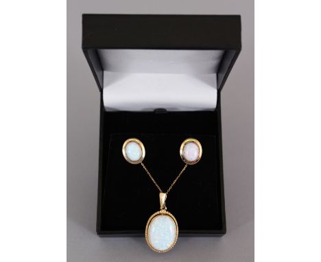 A 9CT GOLD GILSON OPAL PENDANT AND EARRINGS.