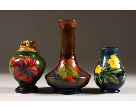 A MOORCROFT POTTERY LIGHTER AND TWO VASES. 4.5ins, 4ins and 6ins high *(3).