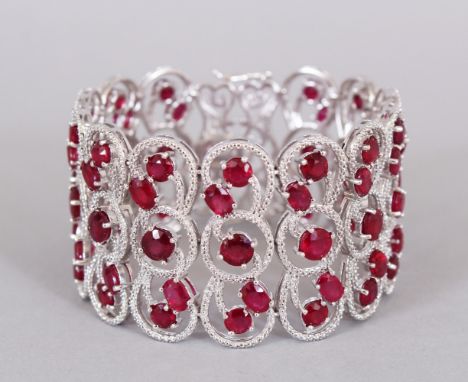 A SUPERB SILVER AND REAL RUBY THREE ROW BRACELET, in a box.