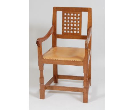 Robert 'Mouseman' Thompson - a joined light oak and lattice work backed elbow chair, having a studded tan leather fixed padse