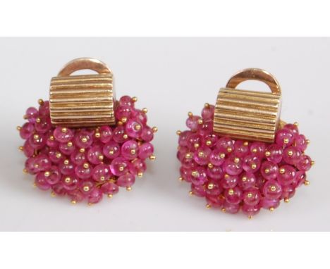 A pair of yellow metal 1960s style multi-bead ruby cluster earrings, each featuring a curved corrugated bar with multiple 3.1