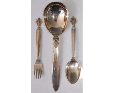 Georg Jensen (1866-1935) - a 1930s sterling silver tablespoon, the handle with raised and floral stylised decoration, otherwi