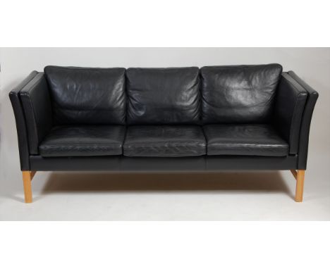 A 1970s Danish black leather three-seater sofa by Skippers, having cushioned upholstery, to slightly outswept sides and raise