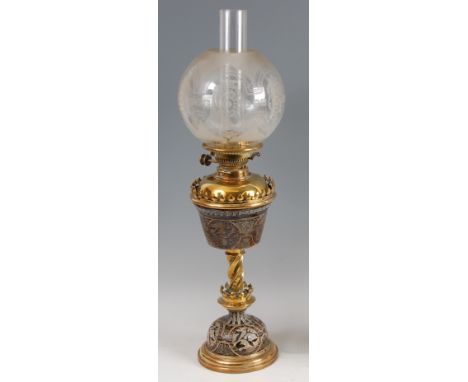 A circa 1900 Doulton Lambeth glazed stoneware and polished brass oil lamp, having floral frosted and acid etched globe shade 