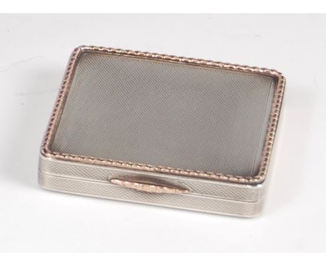 An Art Deco silver and gold trim pocket compact by Hardy Brothers Ltd, the engine turned exterior with raised and applied gol