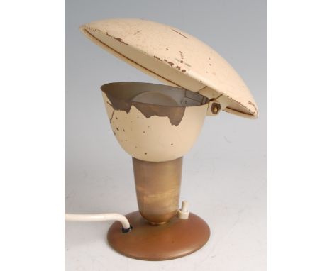 A 1950s Swedish brass and cream painted bedside lamp, having domed adjustable shade, raised on further domed circular foot, h