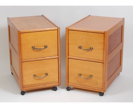 A pair of Art Deco light oak and plywood panelled low two-drawer office filing chests, each with burnished brass handles and 