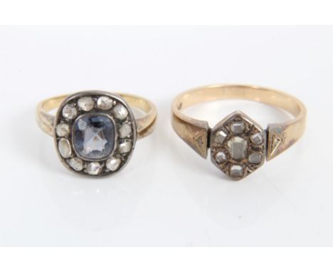 Antique diamond cluster ring with a central mixed cut sapphire surrounded by a border of eleven rose cut diamonds in white me
