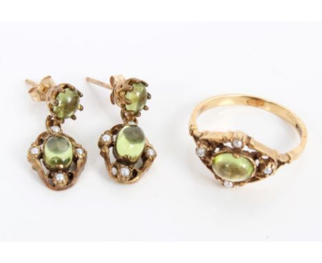 Gold (9ct) peridot and seed pearl ring with a central peridot cabochon surrounded by four seed pearls in an openwork scroll s