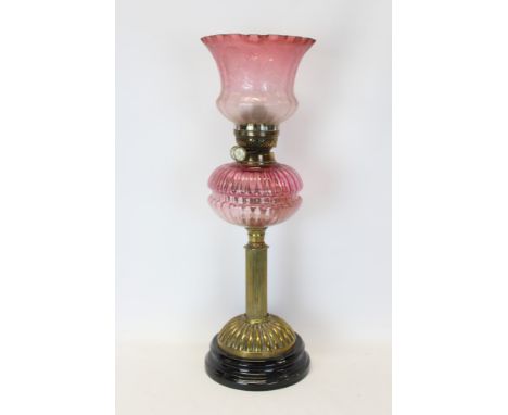 Late 19th / early 20th century oil lamp with Duplex burner, fluted cranberry glass reservoir and etched cranberry glass shade