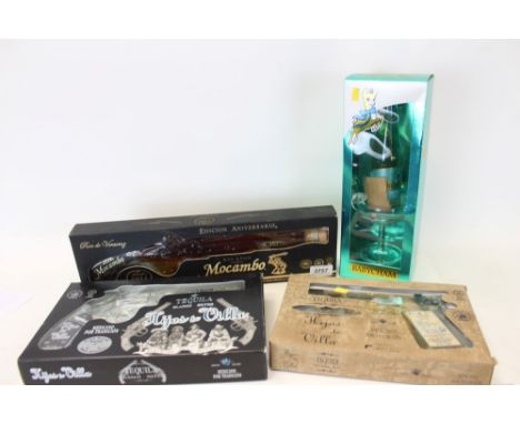 Two novelty bottles of Tequila in the form of pistols, another similar bottle of Mocambo Rum and a bottle of Babycham with gl