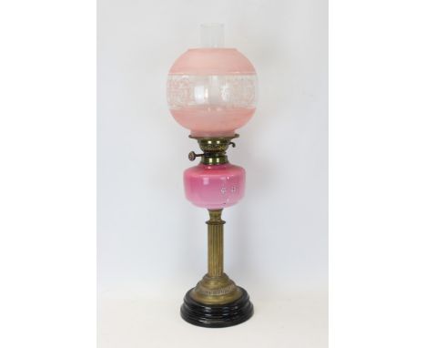 Late 19th / early 20th century oil lamp with 'British' burner, pink ceramic reservoir and etched and frosted pink globe shade