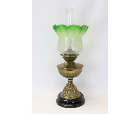 Late 19th / early 20th century oil lamp with English Juno burner, fluted brass reservoir, etched green glass shade with flare