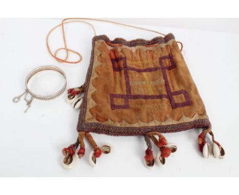 Old African drawstring fabric bag with embroidered design and cowrie shells - sold with a Chinese white metal bangle