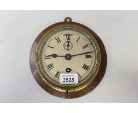 Early 20th century ships' bulkhead clock with white enamel dial, Roman numerals, slow / fast regulator and subsidiary seconds