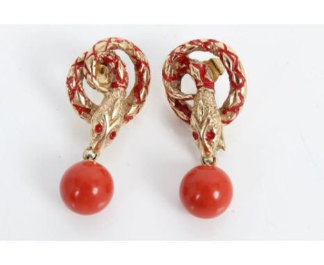 Pair gold (9ct) coiled snake earrings with red enamel decoration, each snake with a red bead suspended from its mouth, 38mm C