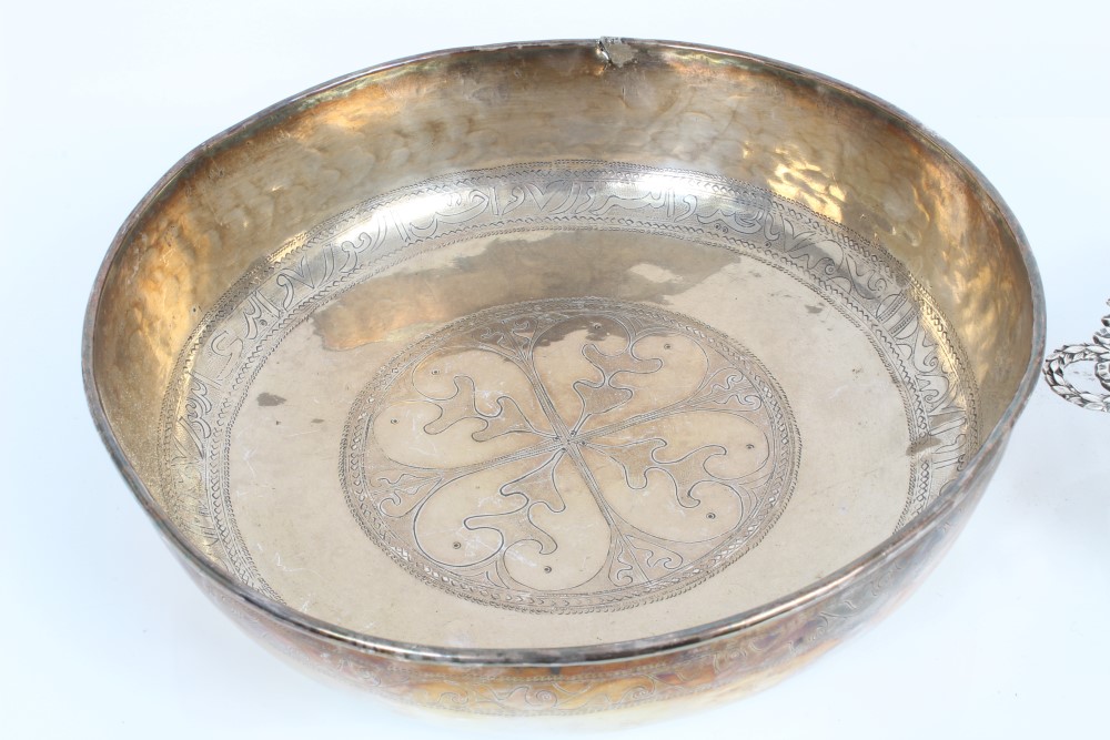 An Old Eastern white metal dish with engraved borders and an early 20th