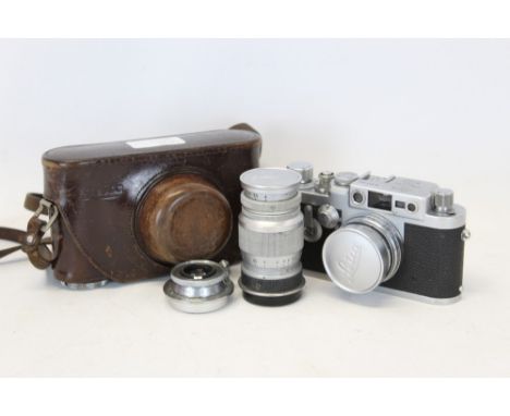 Leica IIIG camera no. 877654, in maker's leather case with three Leitz lenses, 5cm Summicron, 9cm Elmar and 3.5cm Elmar CONDI