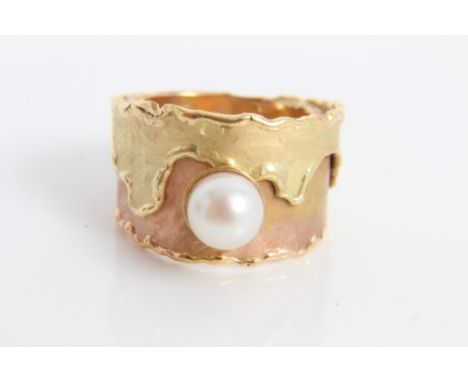 Two-colour yellow metal wide band ring set with a single cultured pearl.  Ring size L CONDITION REPORT Weight 6.3 grams.  Rin