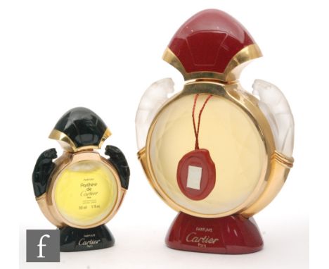Two Panthere de Cartier factice display scent bottles, both circular faceted bottles with a frosted finish in a gilt surround