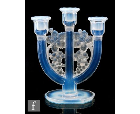A 1930s Art Deco Barolac three light candlestick with grape and vine motifs uniting the branches above a stepped base all in 