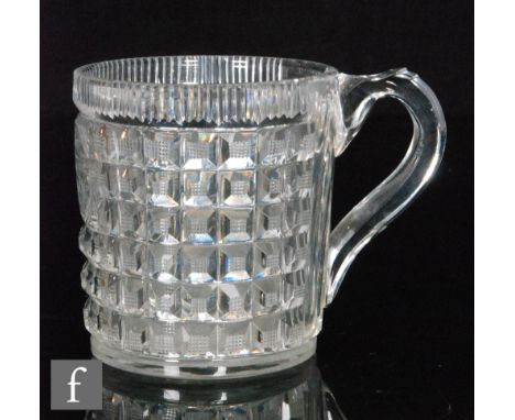 An early 19th Century tankard of cylindrical form with facet cut loop handle, decorated with a cartouche panel with family ar