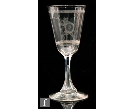 A 19th Century clear crystal drinking glass by John Northwood, the slender round funnel bowl acid etched with a Greek Warrior